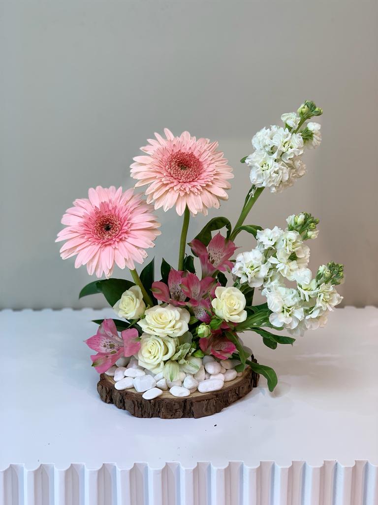 تنسيق الأزهار المختلطة على قاعدة خشبية