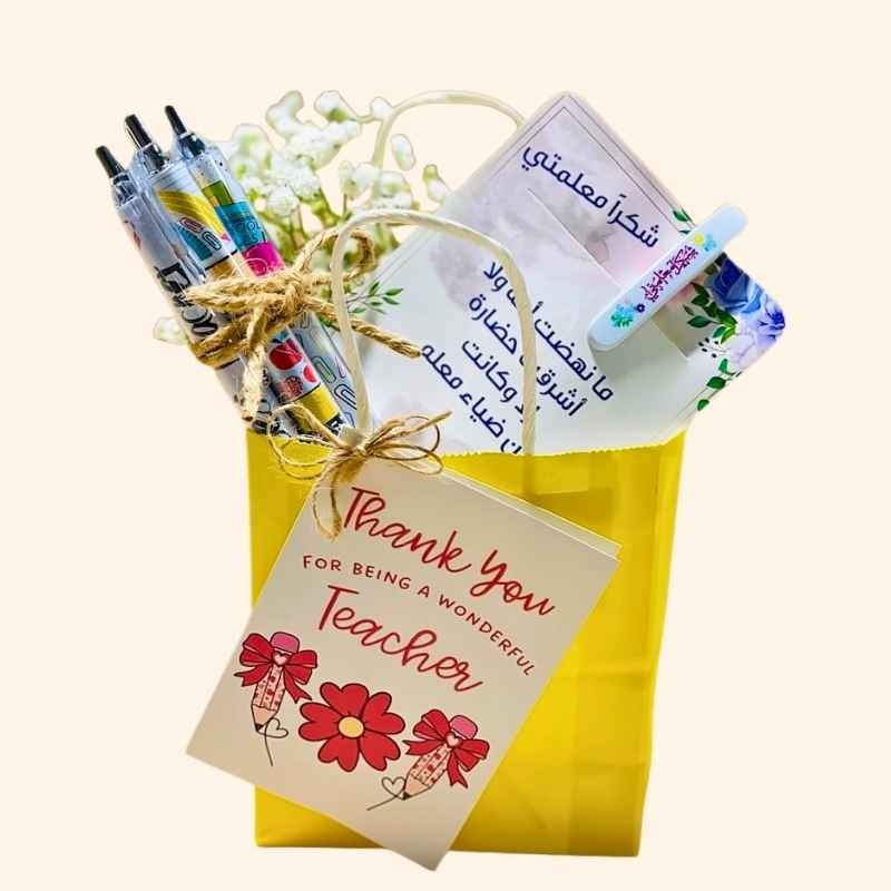 Paper bag for Teacher's Day with pens, flowers and thank you card