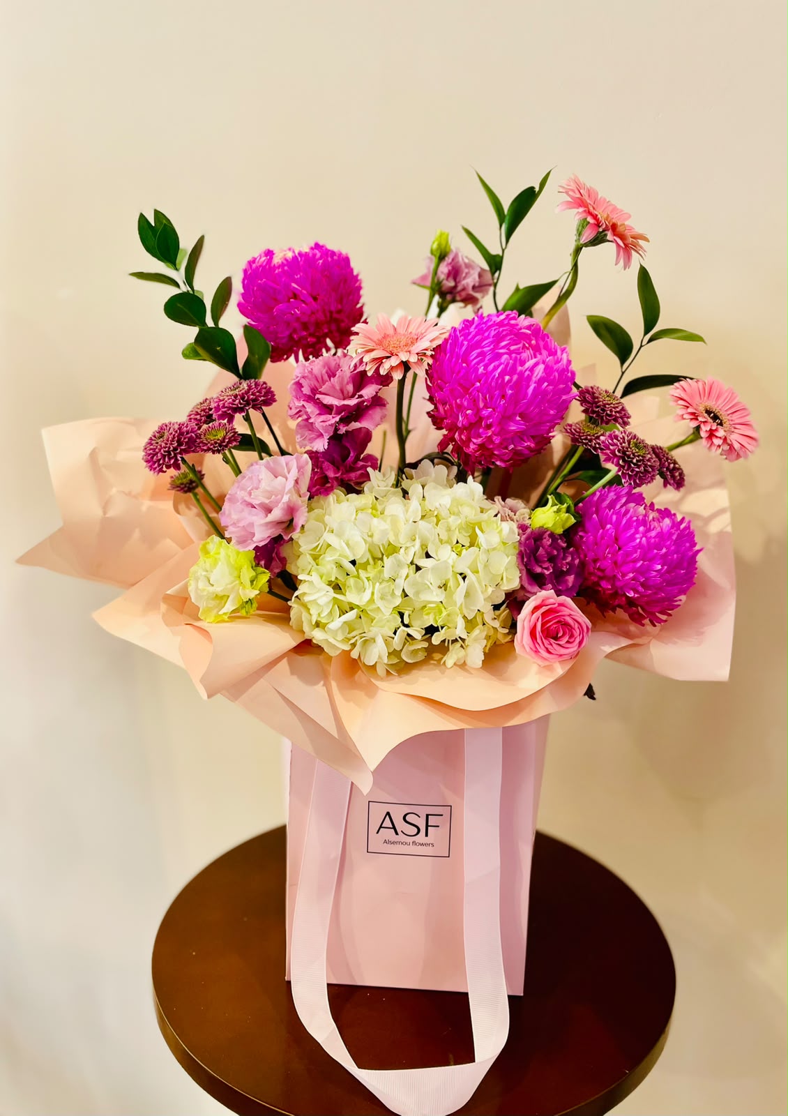 mix pink flowers in a bag bouquet